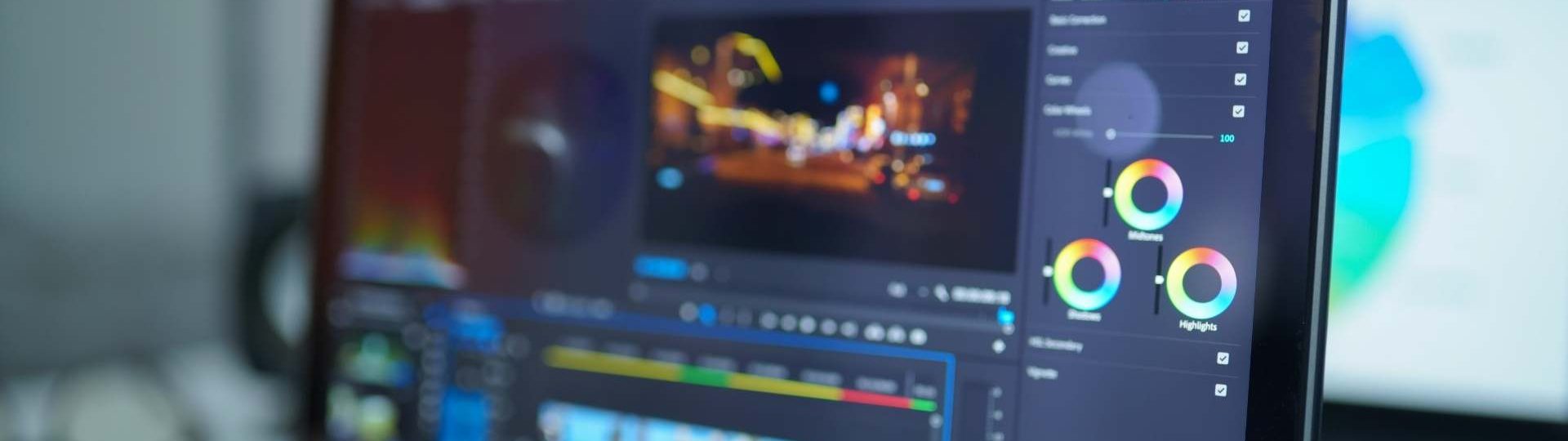 Video editing software open on a laptop with timeline and color correction controls