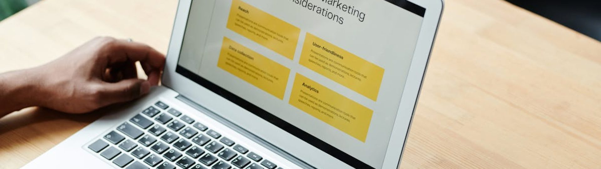 A person using a laptop to review social media marketing strategies at home.