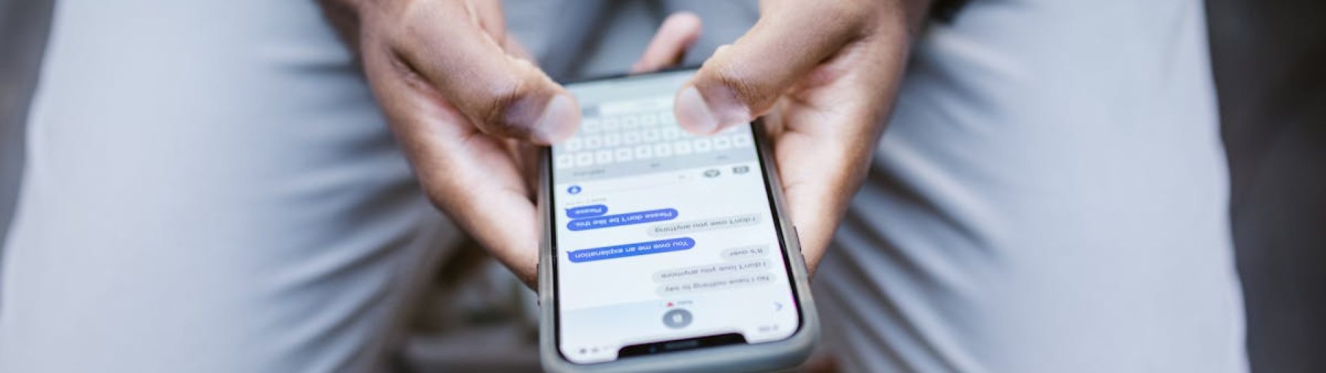 Close-up view of a man texting on a smartphone, capturing communication in action.