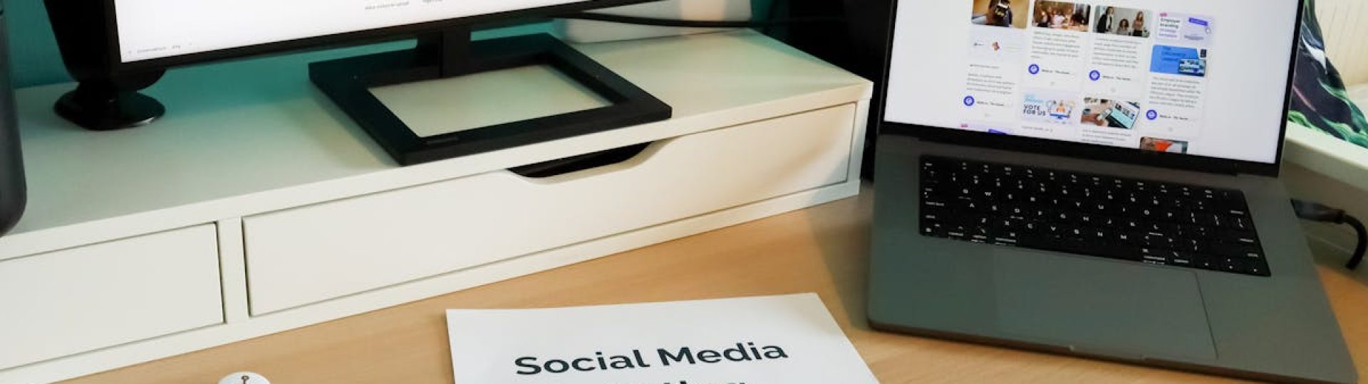 Stylish workspace with laptop and monitor for social media marketing.