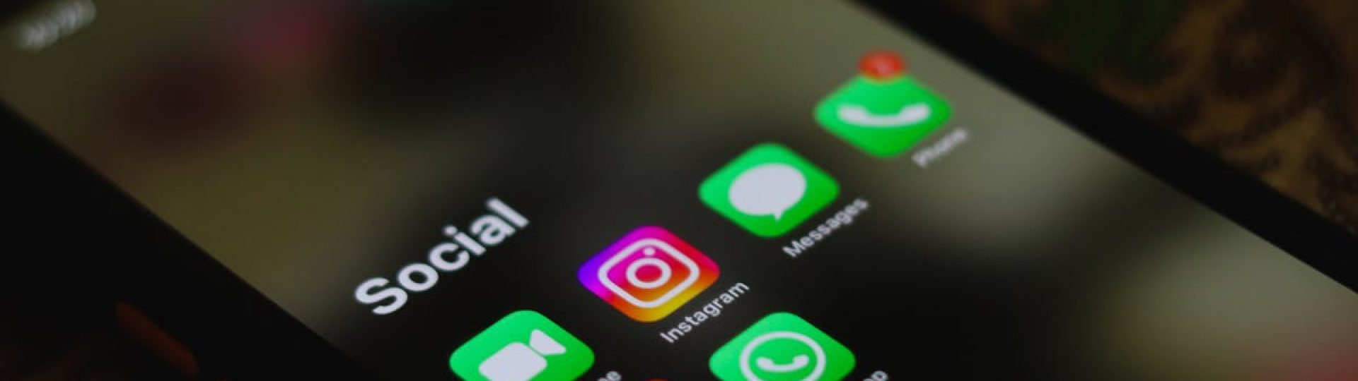 A close-up shot of smartphone displaying social media apps icons on screen.