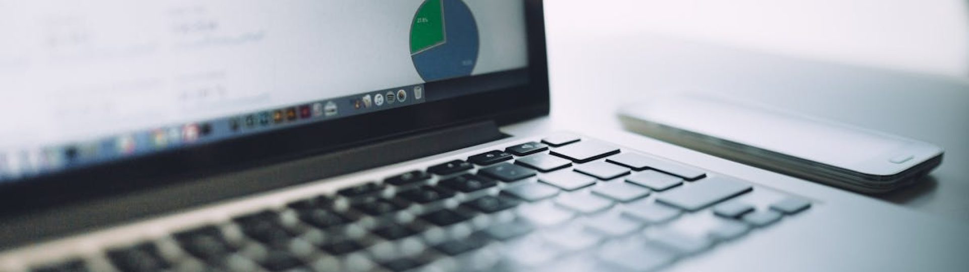 A laptop showing an analytics dashboard with charts and graphs, symbolizing modern data analysis tools.