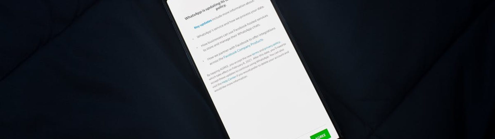 Close-up of smartphone screen showing a privacy policy update agreement.
