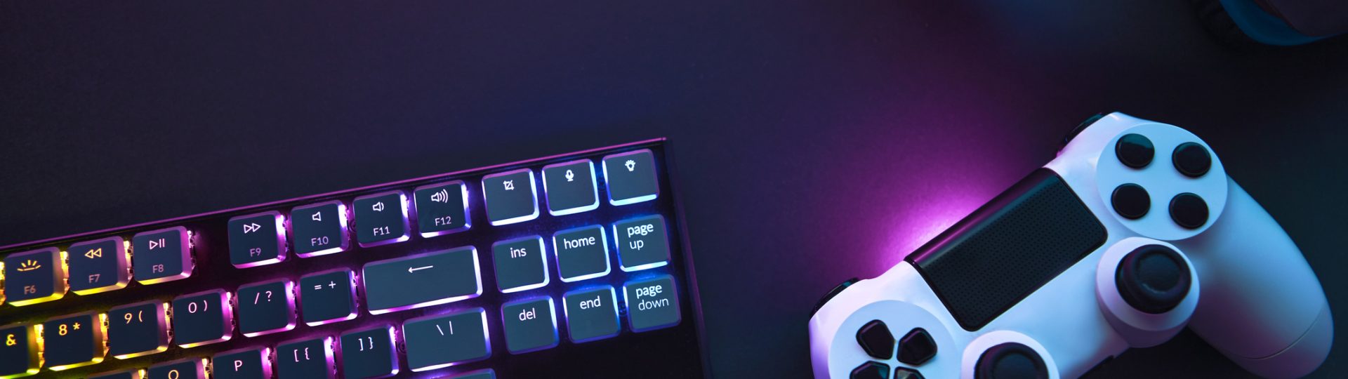 Top down view of colorful illuminated gaming accessories laying on table.