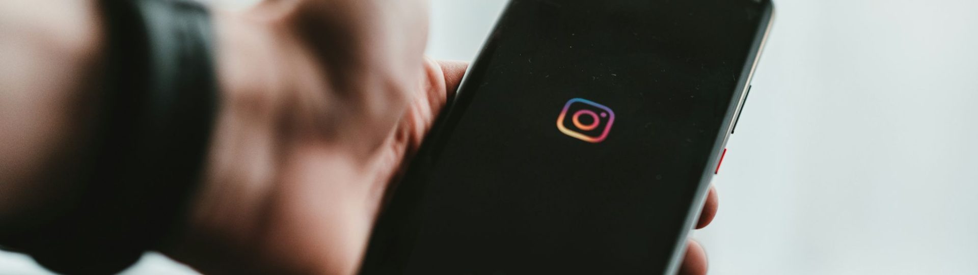Person holding a smartphone with the Instagram app open