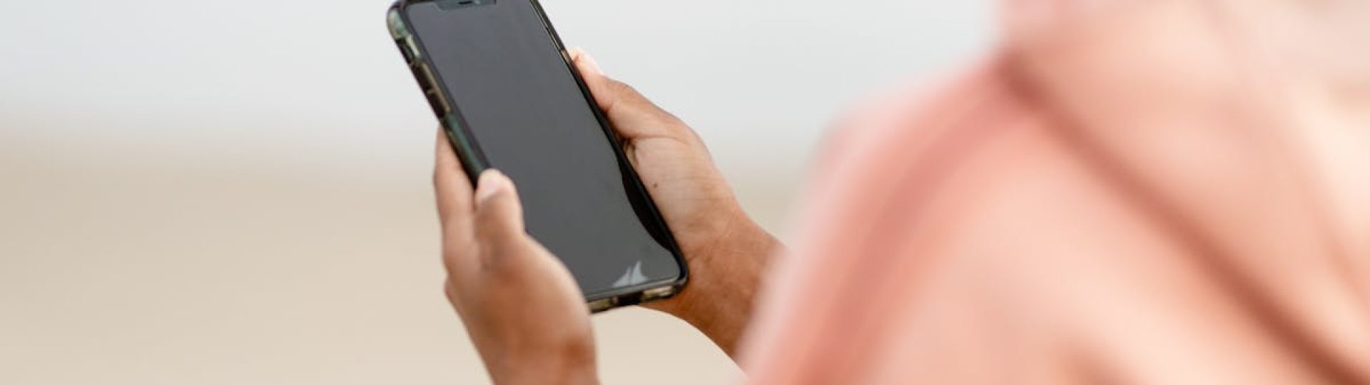 Close-up of a person using a smartphone outdoors, focusing on modern technology.