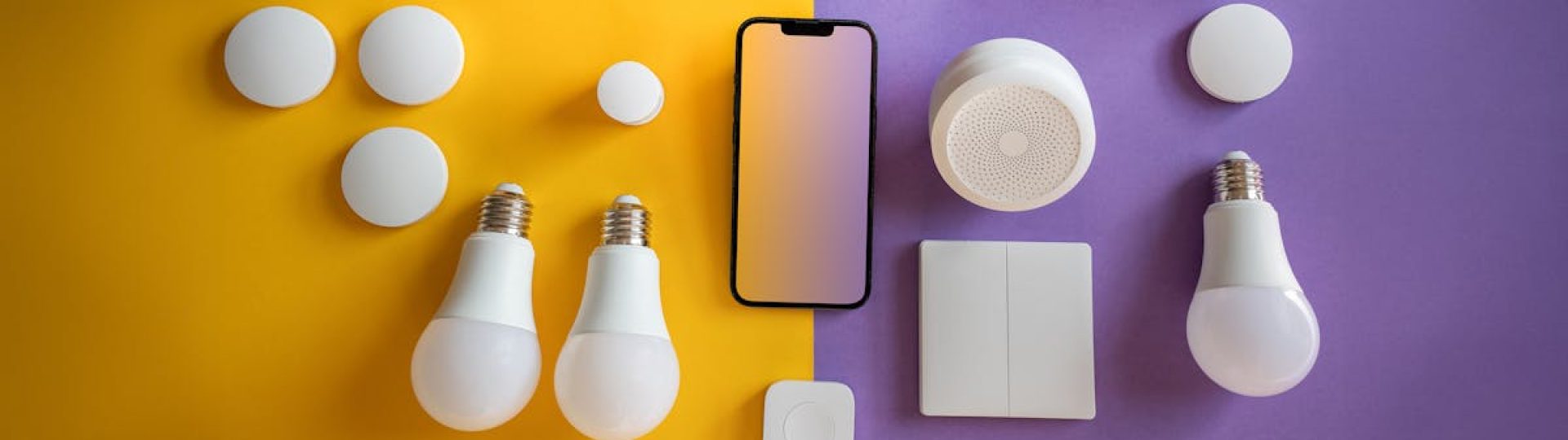 Flat lay of electronics, smart home gadgets on a colorful background for tech concepts.
