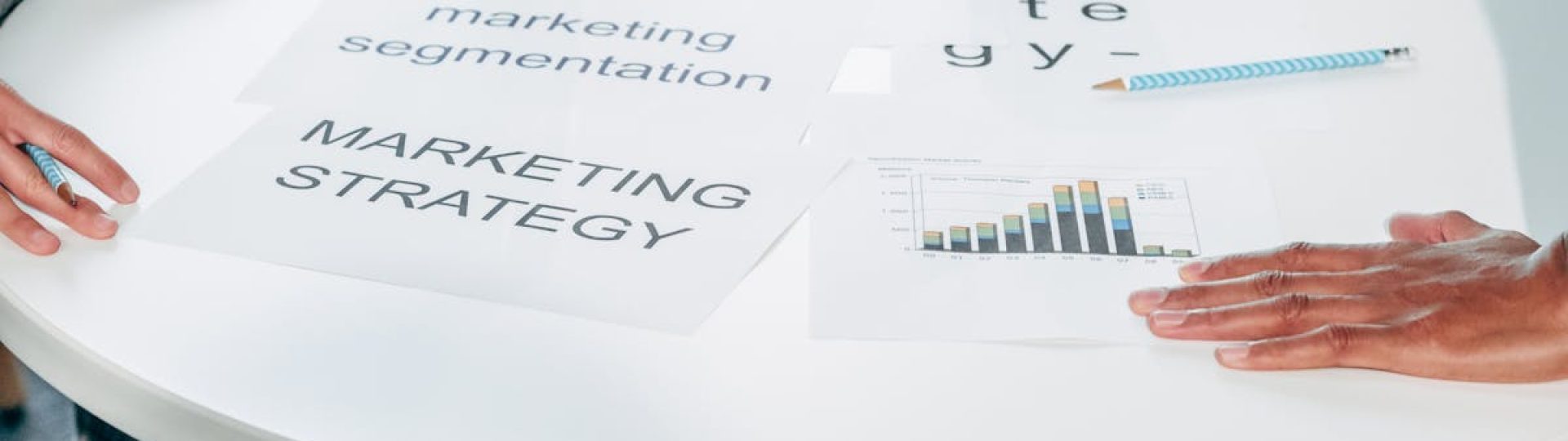 Two professionals collaborate on marketing strategy and segmentation at a round table.
