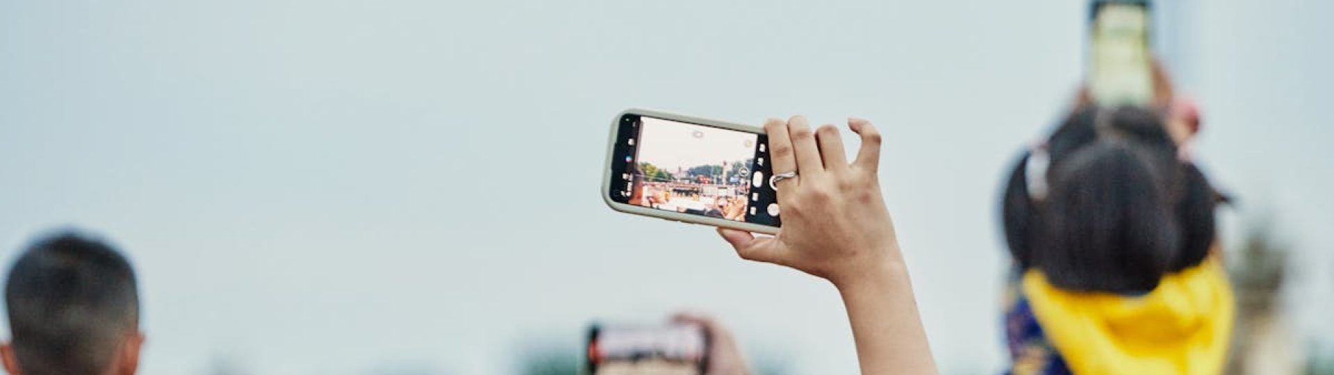 A lively crowd capturing an event on smartphones, showcasing modern digital engagement.