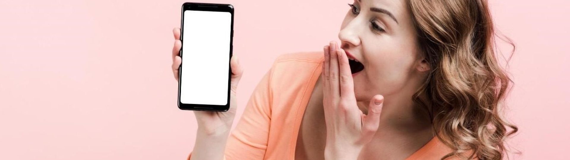 shocked-young-woman-looking-at-phone-screen-place-for-advertising-free-photo (1)