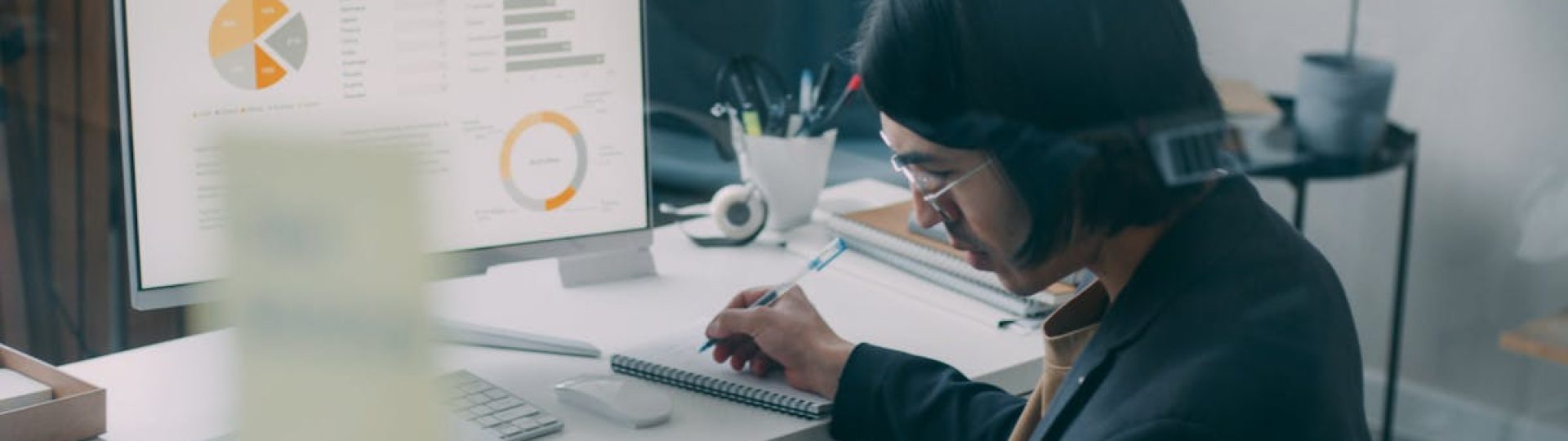 Business person reviewing analytics and charts at a modern office desk.