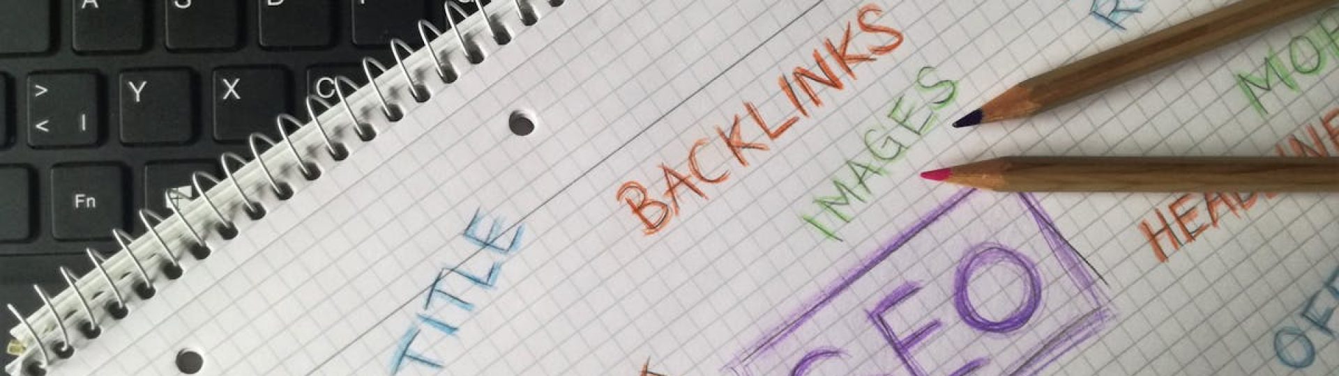 Close-up of notebook with SEO terms and keywords, highlighting digital marketing strategy.