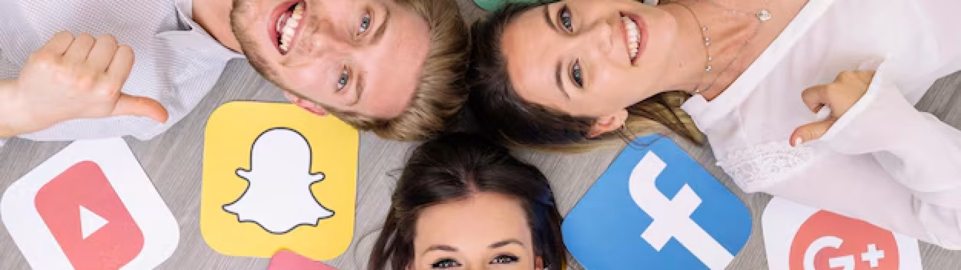 young-smiling-friend-lying-floor-with-social-media-logos-showing-thumbup-sign_23-2147847534